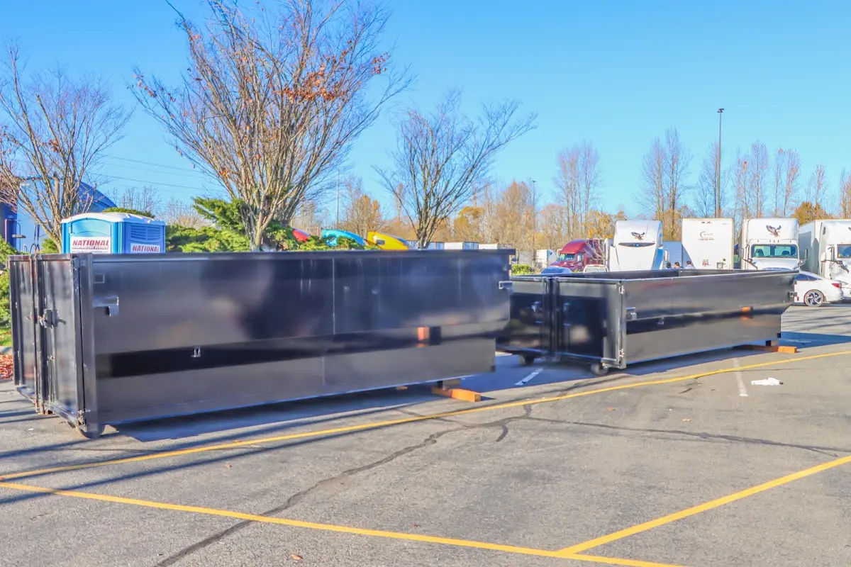 Professional dumpster rental service with roll-off container on residential driveway in Portland